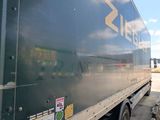 a semi truck that is parked under a bridge