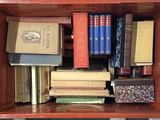 a wooden box with many books on top of it