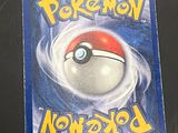 a pokemon card on a table with a black background