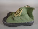 a close up of a pair of green shoes on a table