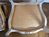 two chairs that have been painted white and are sitting on the floor
