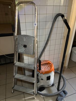 an image of a vacuum and a ladder in a bathroom