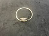 a silver ring sitting on top of a black surface