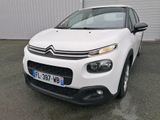 the front of a white citrole parked in front of a building