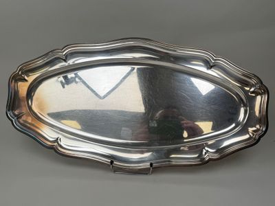 a silver tray with a mirror on it on a table