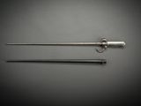 a pair of swords and a spear on a gray background