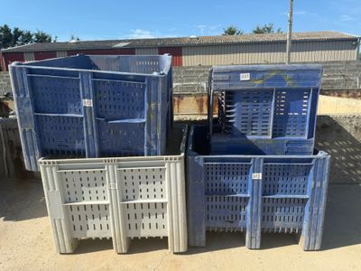 many crates that are stacked up in the dirt