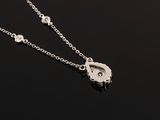 a close up of a necklace on a black surface