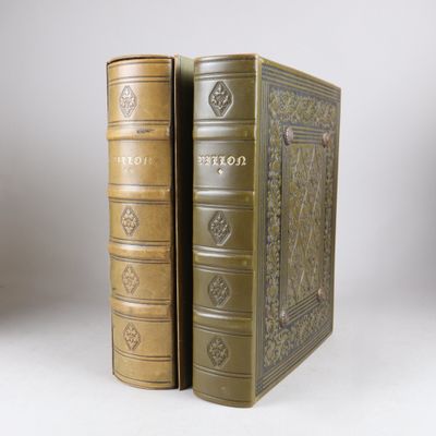 an old book sitting on top of a table next to a book case