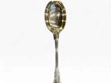 a spoon with a spoon handle on it on a white surface