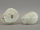 two white vases sitting next to each other on a table