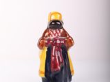 a small figurine of a man with a hat and scarf