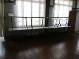 a bench in the middle of a room with wooden floors