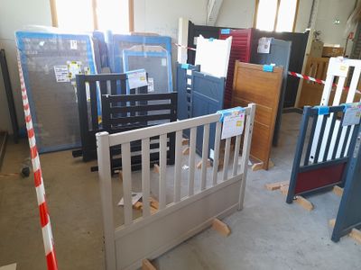a baby crib in the middle of a room filled with furniture