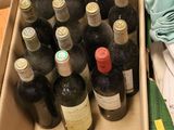 many bottles of wine in a box on the floor