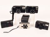 three cameras that are sitting next to each other on a table