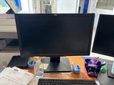 two computer monitors and a keyboard on a desk