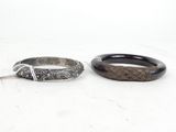 two black and silver rings on a white surface