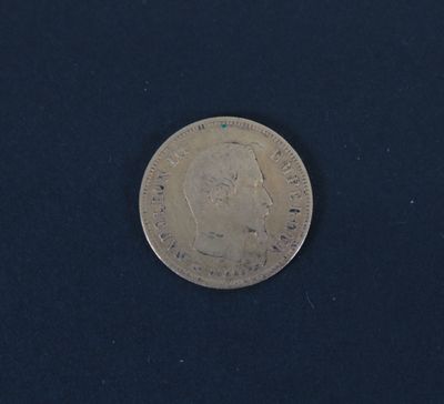 a close up of a silver coin on a black surface