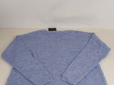 a blue sweater sitting on top of a white table