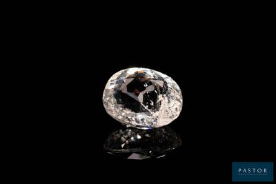a white diamond on a black surface with a black background