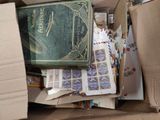 a box full of stamps and a book on top of it