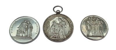 three silver medals of jesus and mary on a white background