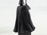 a close up of a star wars figurine on a white surface