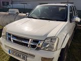 a picture of a white suv parked in a yard