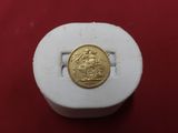 an image of a gold coin sitting on top of a white box