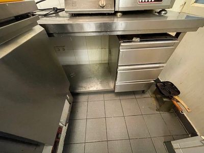 a kitchen with a stove, oven, and cabinets in it