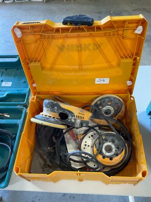 a yellow tool box with tools in it on a table