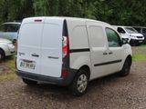 a white van parked in a parking lot next to other cars