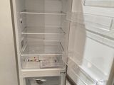 an empty refrigerator with its door open in a kitchen