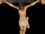 a statue of jesus on the cross on a black background