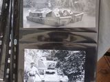 several black and white photos of military vehicles on display on a table