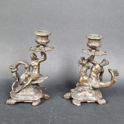 pair of antique silver candlesticks with a lady and a dragon