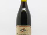 an image of a bottle of red wine on a white surface