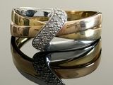 a stack of rings with a black bow on top of them
