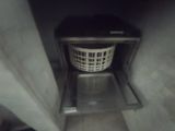 a basket that is inside of a toilet in the bathroom
