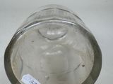 a glass vase with a label on it on a table