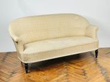 a couch sitting on a parquet floor in a room