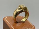 an image of a gold ring sitting on top of a wooden box