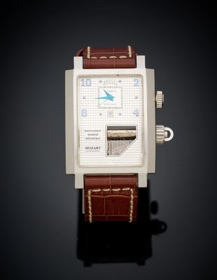 a close up of a watch on a black surface