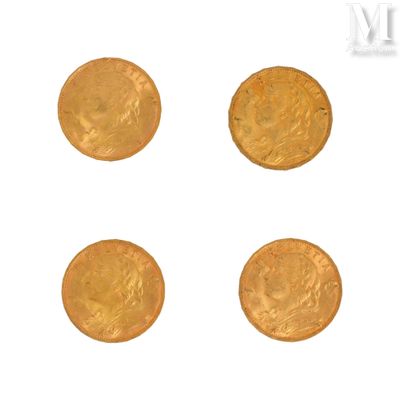 four gold coins are arranged in a row on a white surface