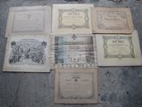 several old books sitting on top of a cement floor next to each other