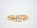 a close up of a gold ring with a diamond in the center