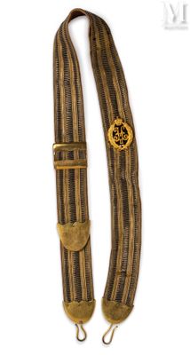an old style guitar strap with a wooden button on it