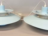 two lamps that are sitting on a table in a room