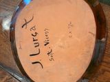 a plate with writing on it sitting on a wooden table